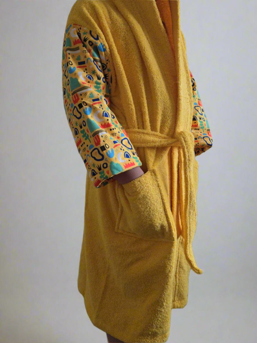 Yellow kids' bathrobe with nature-inspired print, made from soft and absorbent Turkish cotton for comfort and warmth