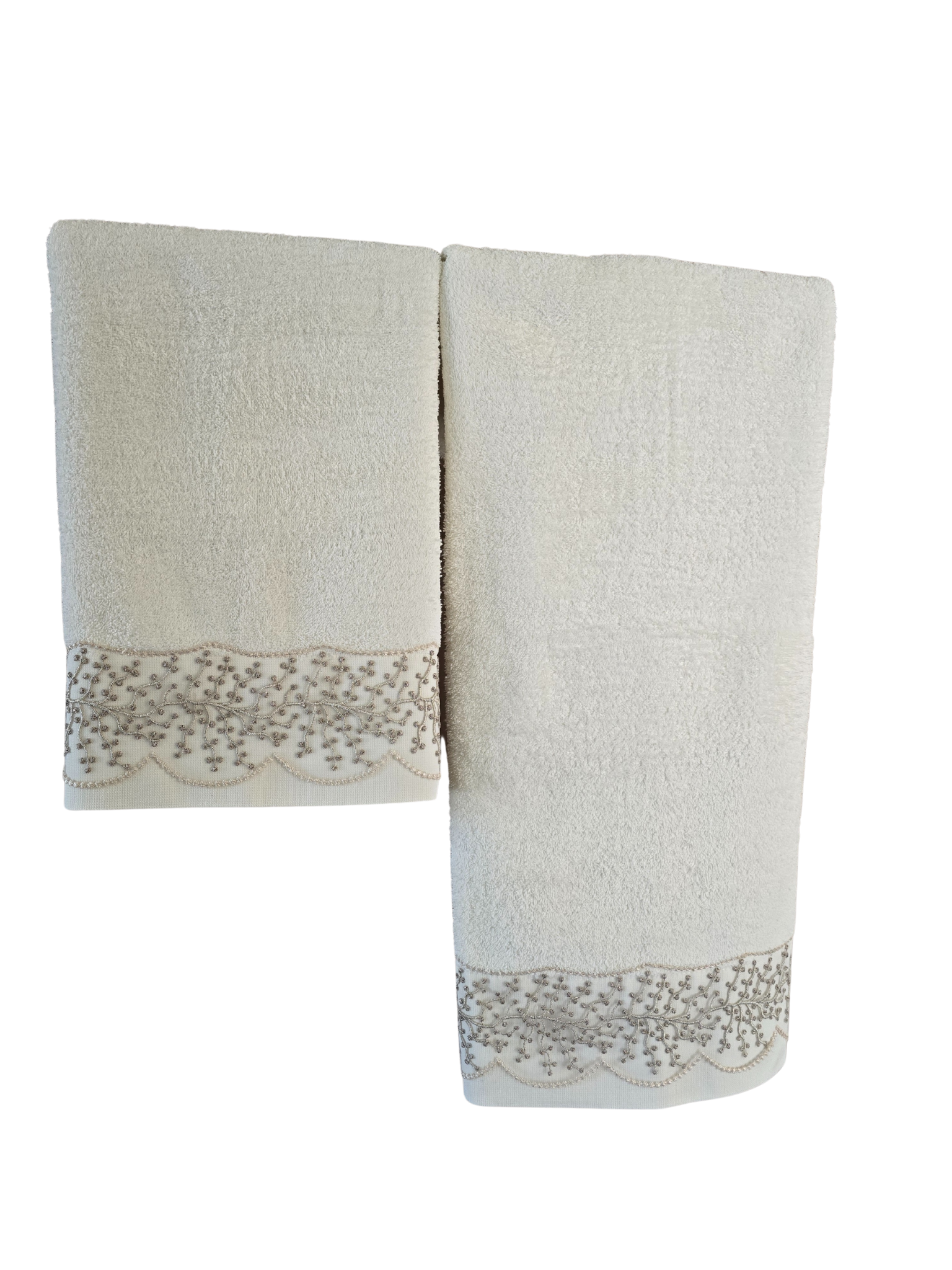 Pair of beige towels with lace trim on a white background